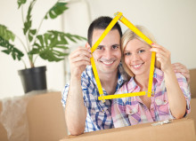 Happy smiling couple moving into first new home