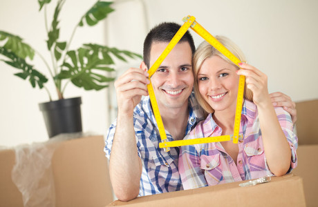 Happy smiling couple moving into first new home